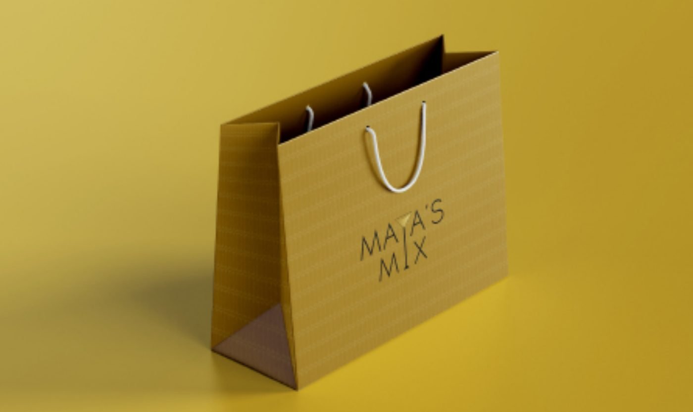 Maya's Mix logo on a mustard paper shopping bag